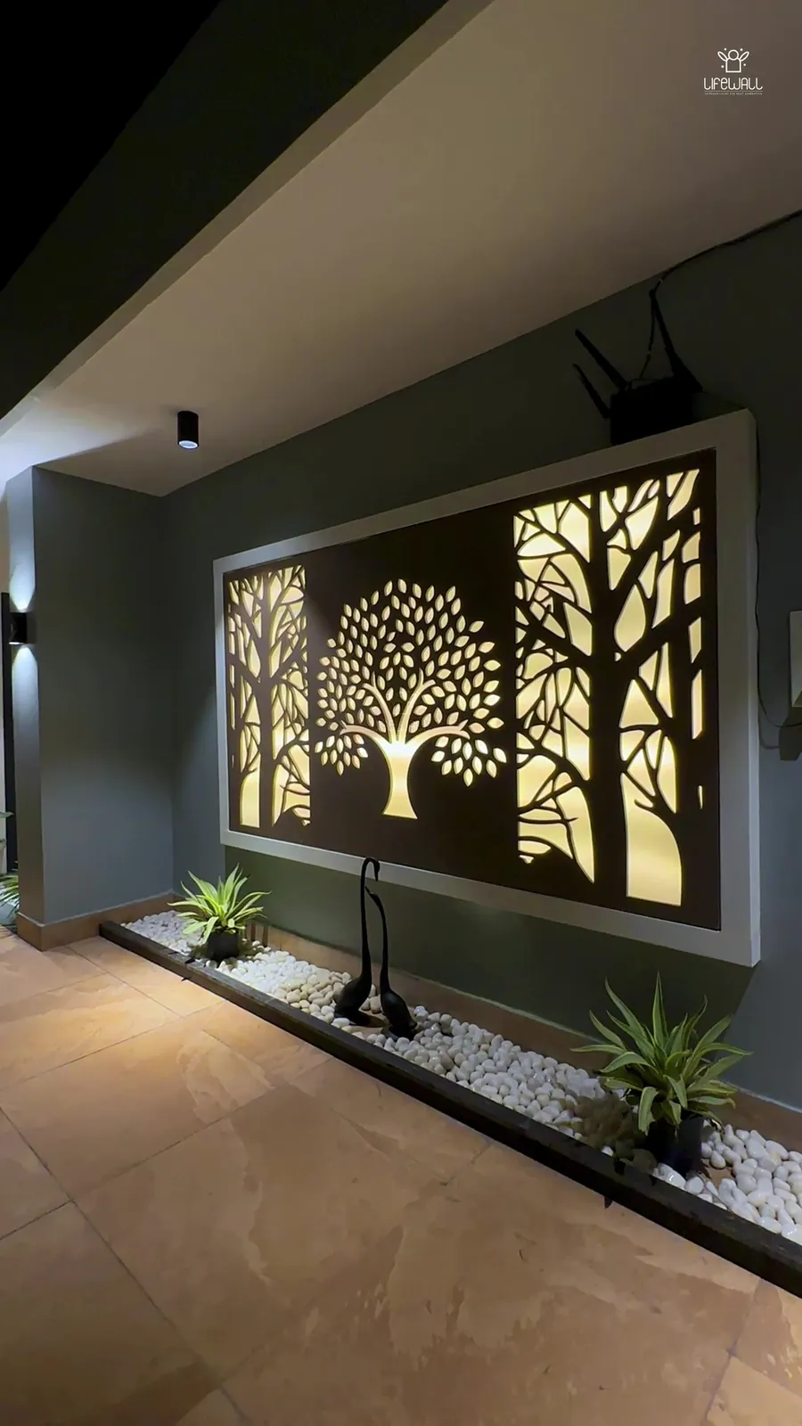 Film of a terrace with backlit tree wall