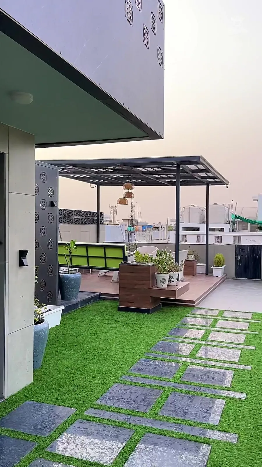 Film of a terrace with water wall and lawn